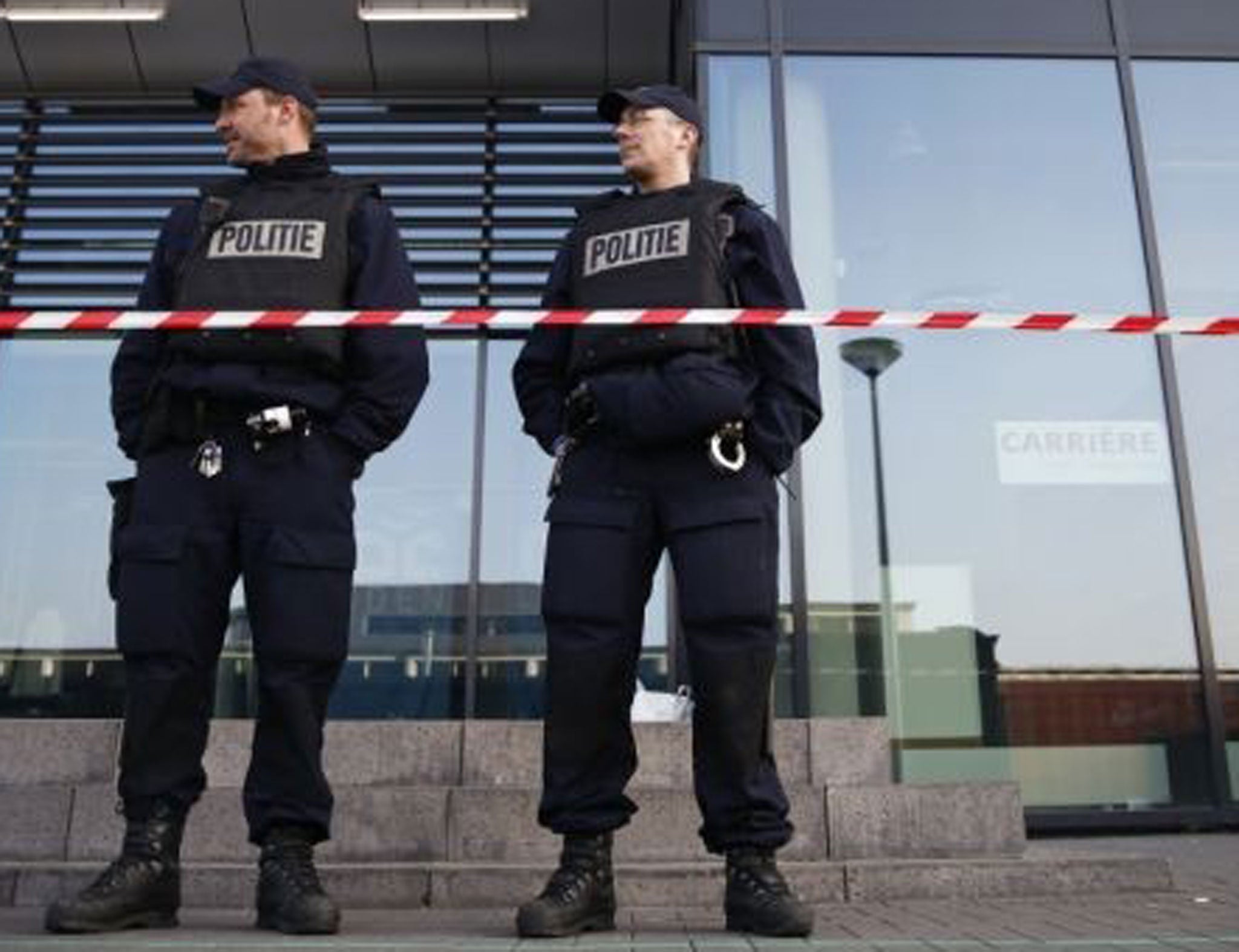 Police officers stand in front of the ROC College in Leiden