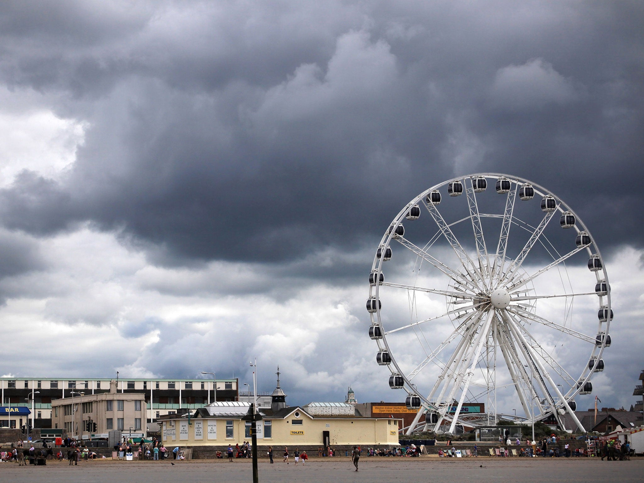 Rain clouds gather above the big wheel on the seafront on August 30, 2011 in Weston-Super-Mare, England.