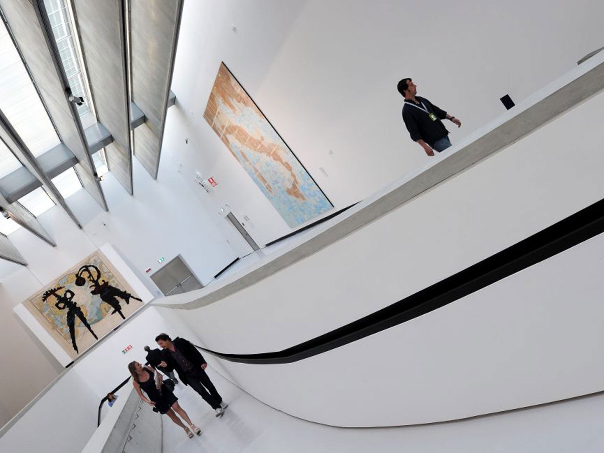Visitors walk at the Maxxi, Italy's first national museum of contemporary art designed by Zaha Hadid