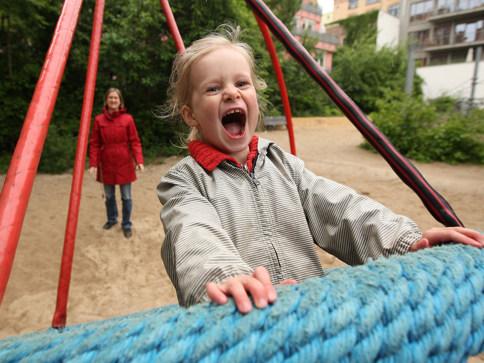 A mother pushes her three-year-old daughter on a swing on a playground on June 6, 2012 in Berlin, Germany. The Betreuungsgeld (child care subsidy), proposed to take effect in January 2013, would give parents that keep their children at home instead of sending them to a kindergarten €150 per child per month, causing concern amongst critics who feel that the state support would foster traditional family values as well as provide an incentive for low-income families to keep their children at home.
