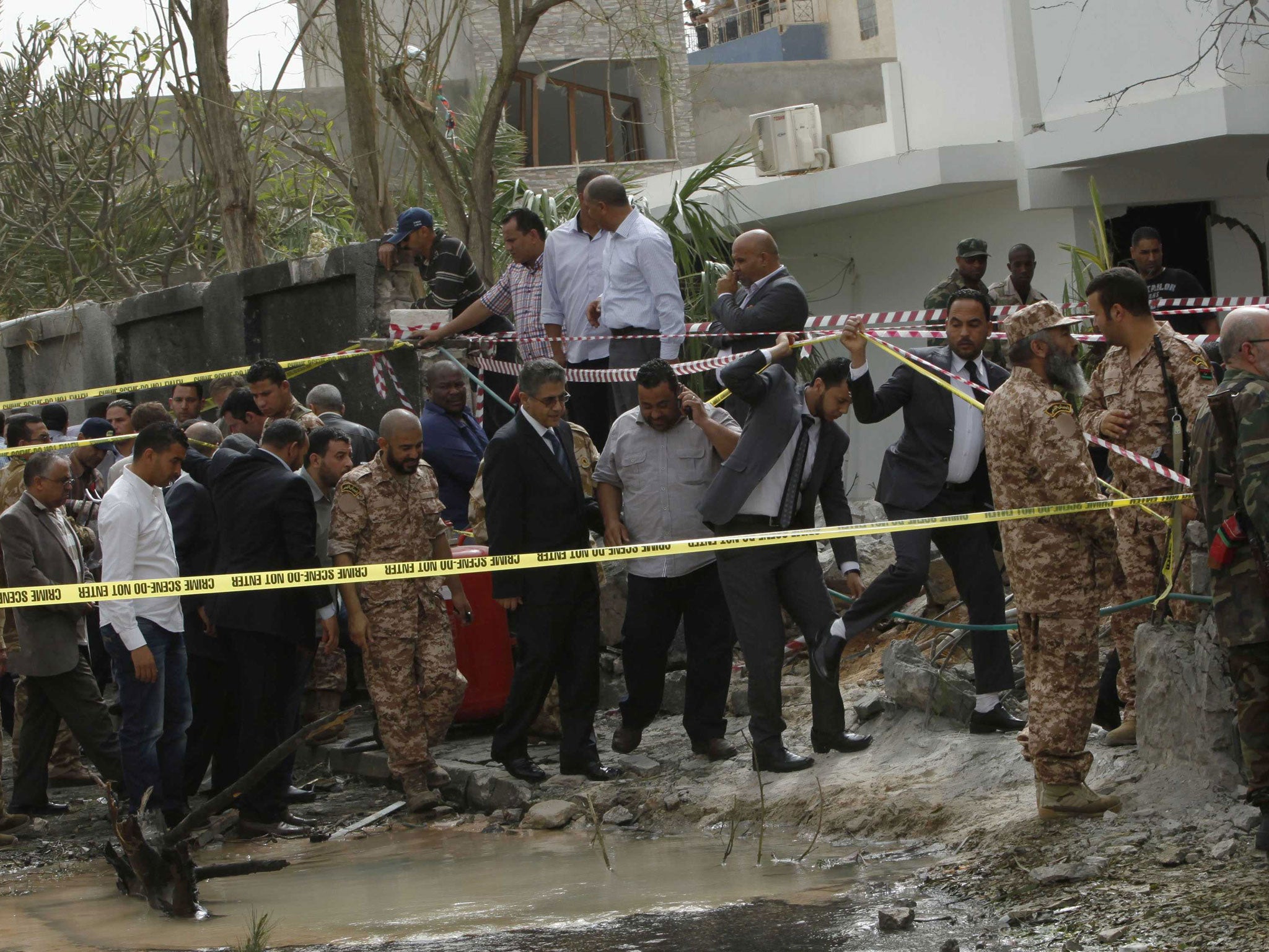 Libyan Interior Minister Ashour Shuail (centre) inspects the scene near the French embassy in Tripoli