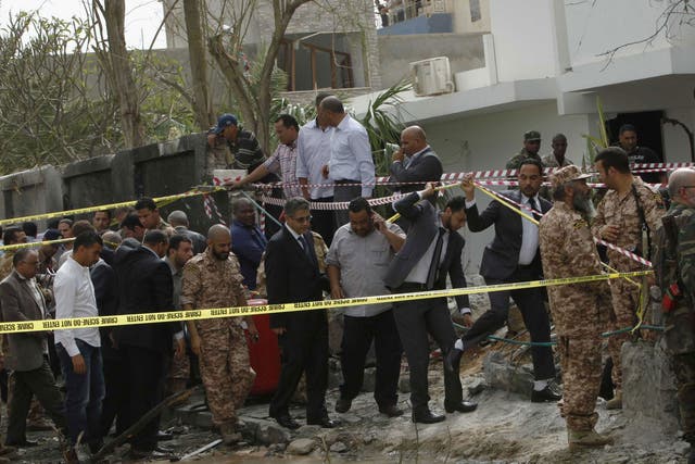Libyan Interior Minister Ashour Shuail (centre) inspects the scene near the French embassy in Tripoli