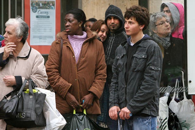 People wait for public transport at a bus-stop in Kingston Upon Thames town centre on April 19th, 2008 in London, England.