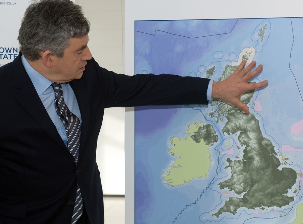 Former British Prime Minister Gordon Brown stands with a map of the plans for a new initiative to build off-shore wind farms ahead of a press conference at Millbank Tower in central London, on January 8, 2010
