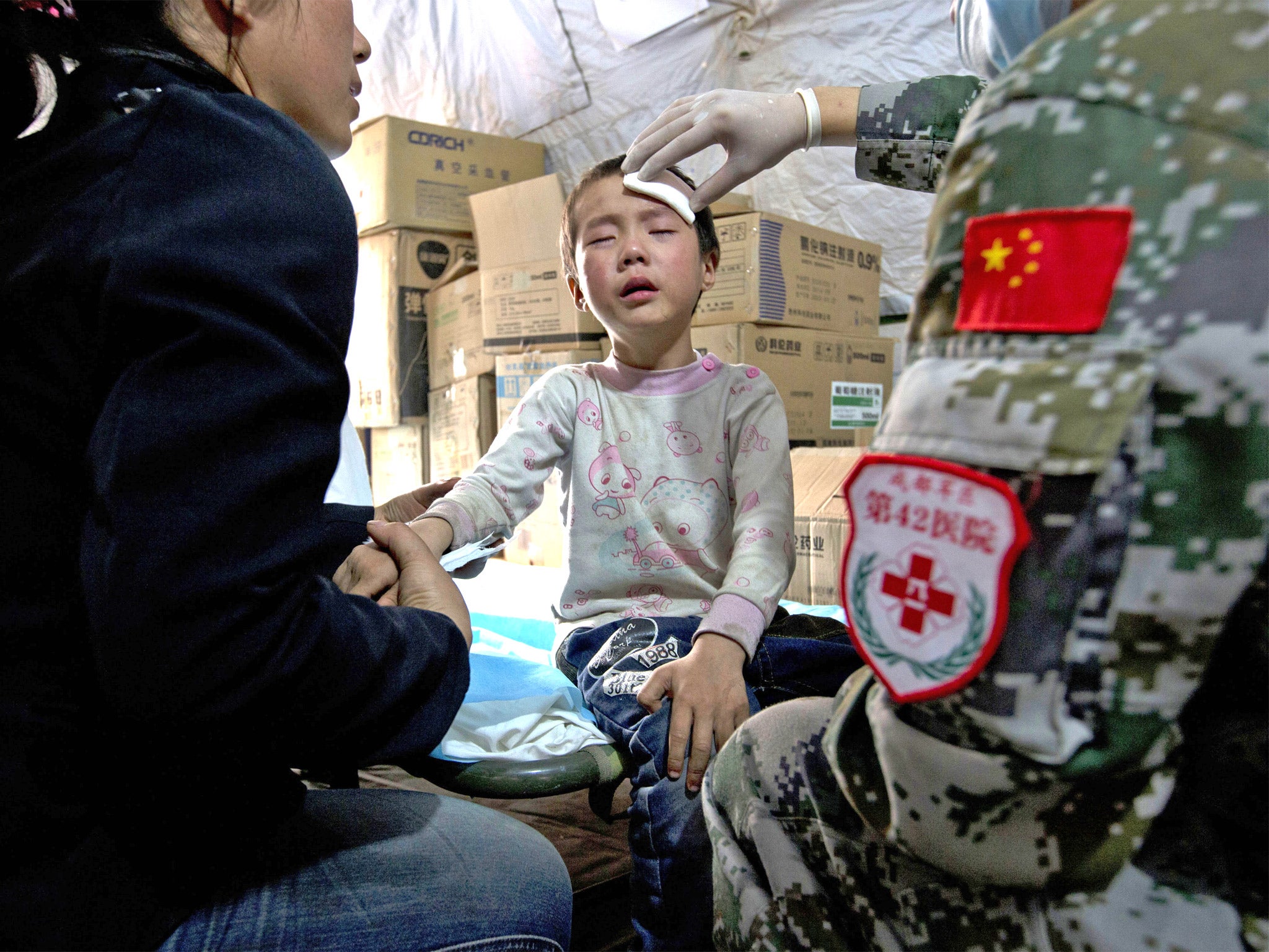 A child gets treatment in a military field hospital in Lushan, Sichuan