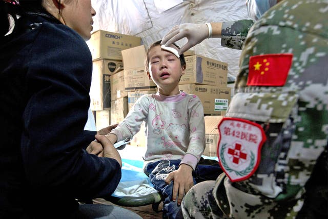 A child gets treatment in a military field hospital in Lushan, Sichuan 