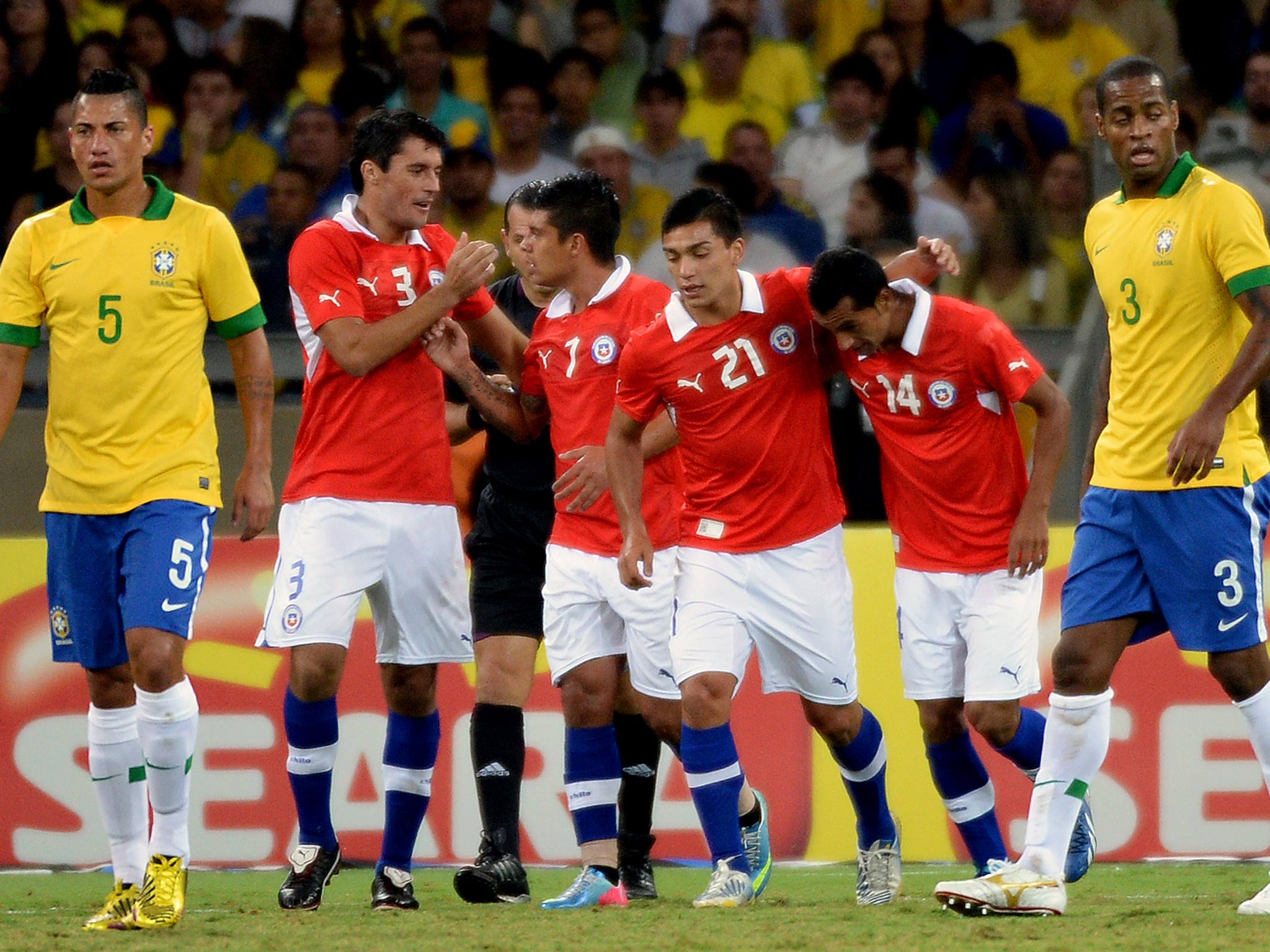 Chile's Marcos Gonzalez (2nd L) celebrates with teammates after scoring against Brazil, during their friendly football match at the Mineirao stadium