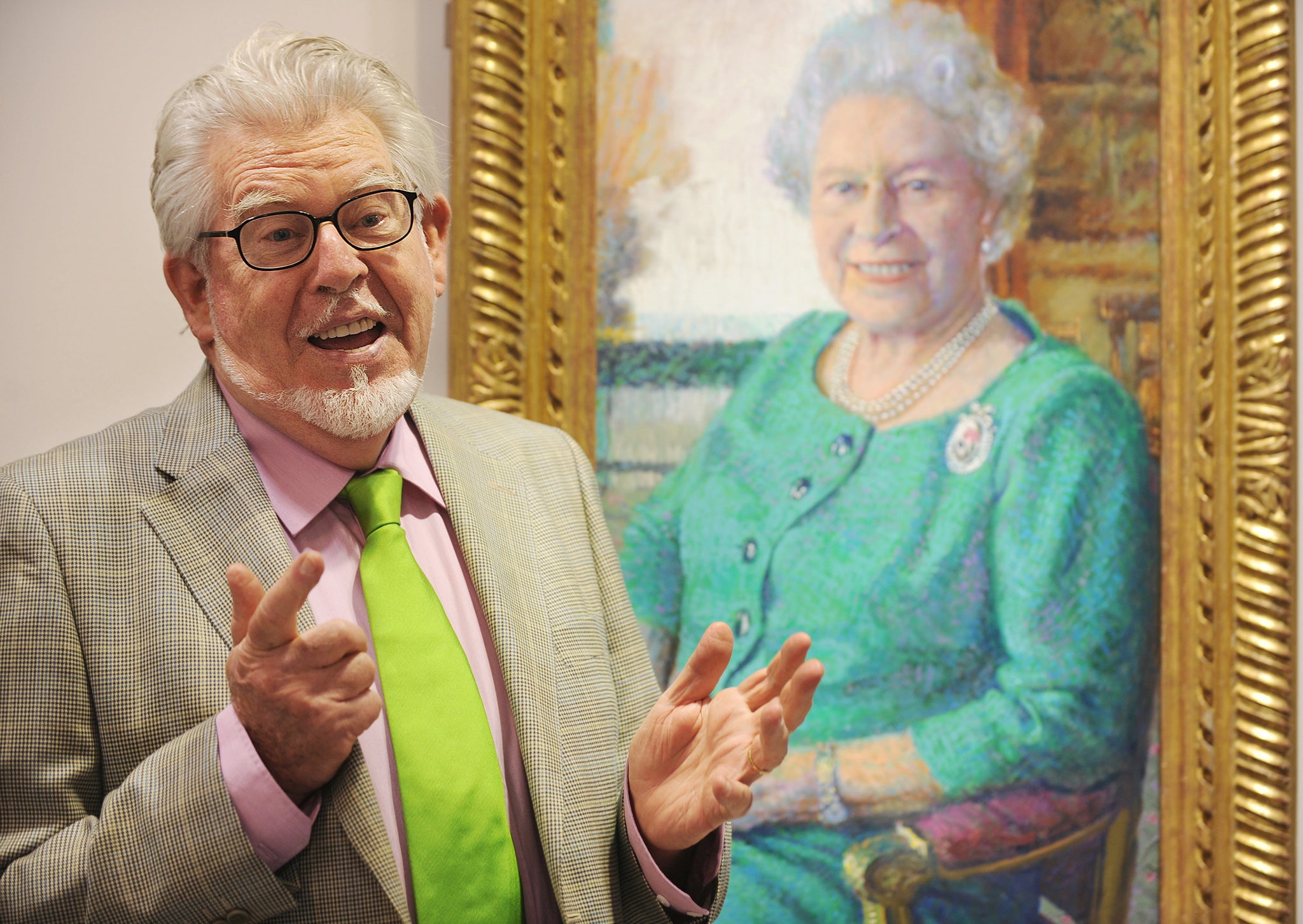 Rolf Harris with his portrait of the Queen at a London art gallery in 2010