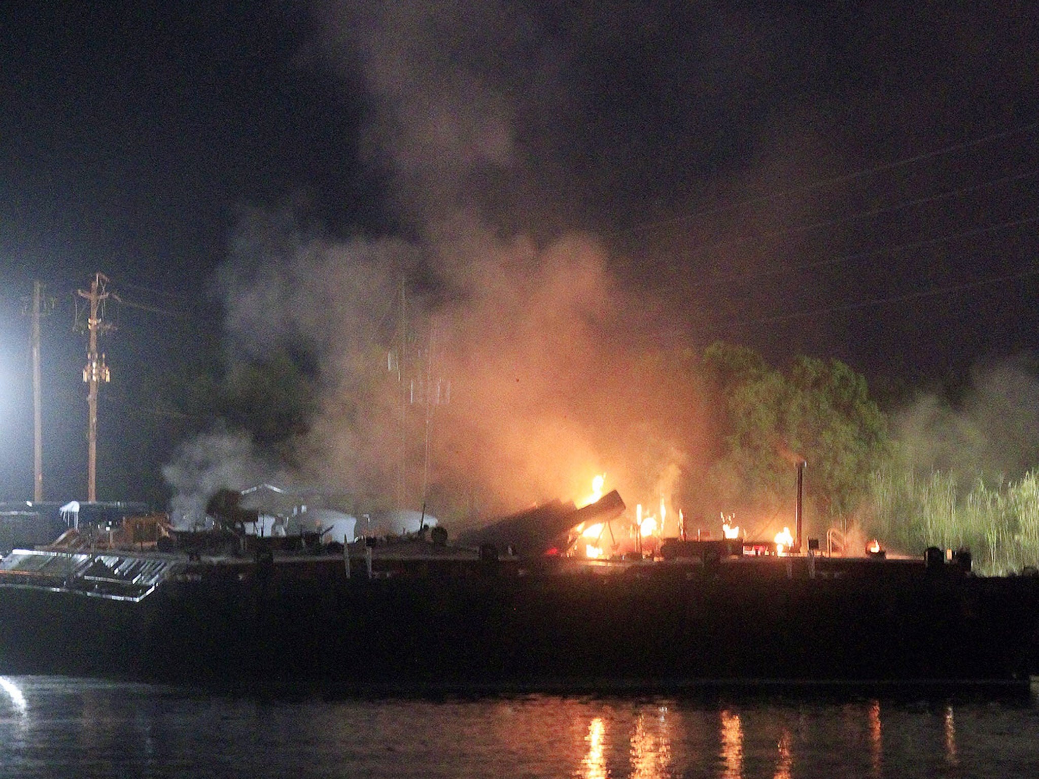 Fire burns aboard a fuel barge near Mobile in Alabama