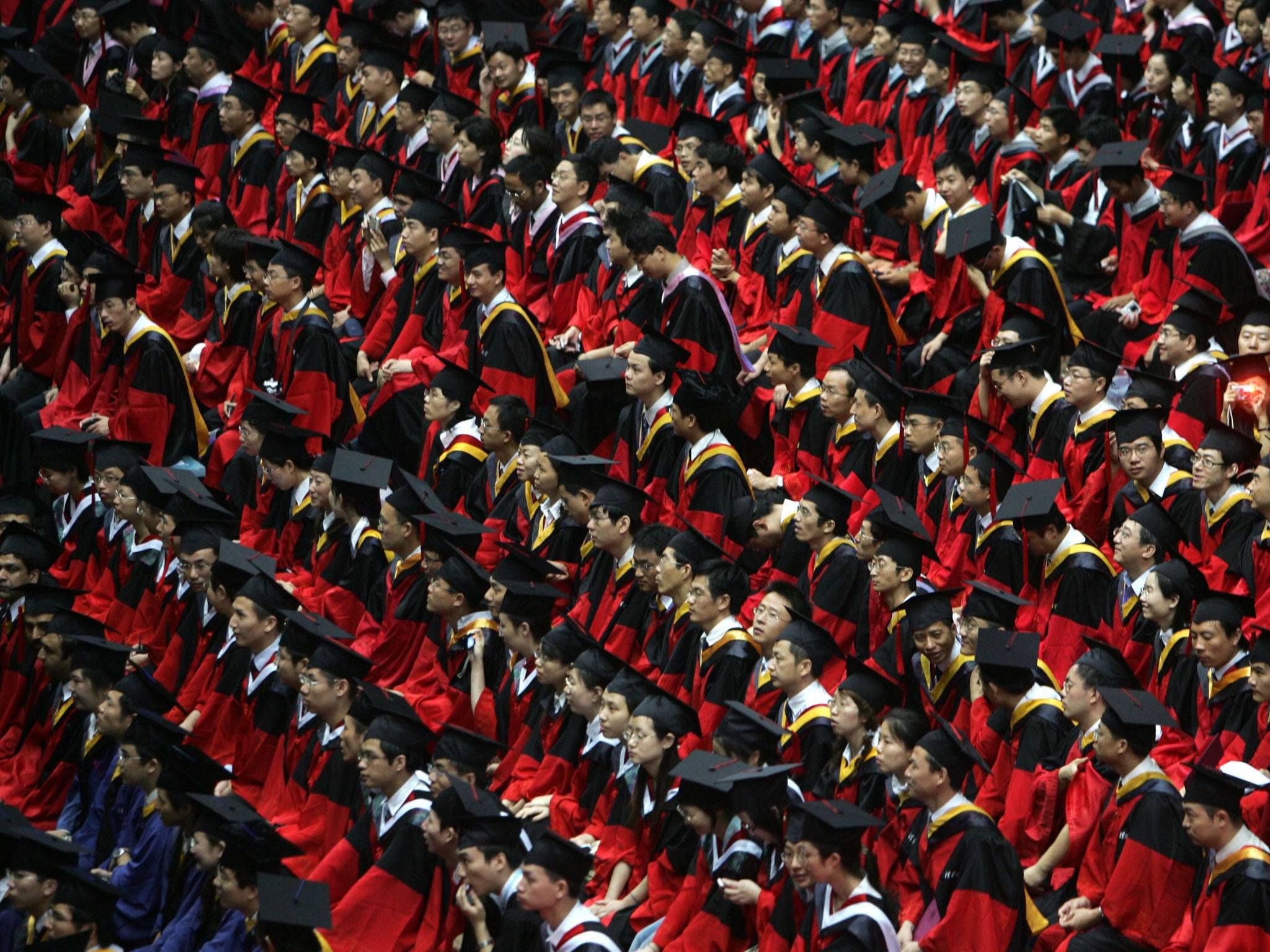 Students graduate during a ceremony held for 3,768 master and 898 doctorates being given out at the Tsinghua University on July 18, 2007 in Beijing, China.