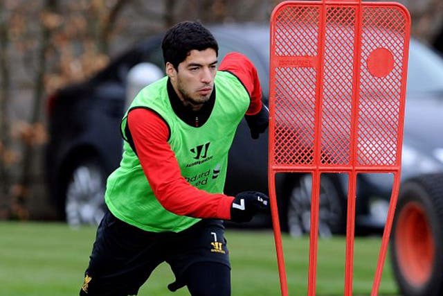 Luis Suarez takes part in a Liverpool training session yesterday