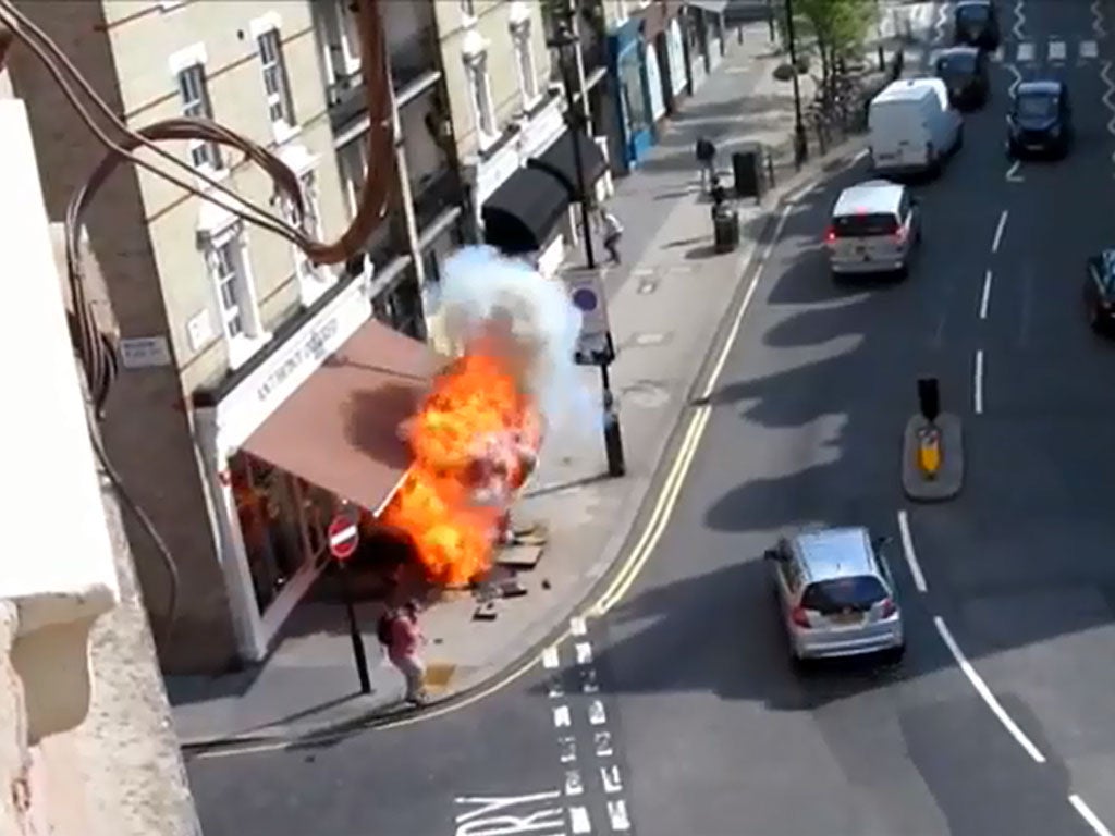 A man stands by as the gas pipe explodes on Pimlico Road