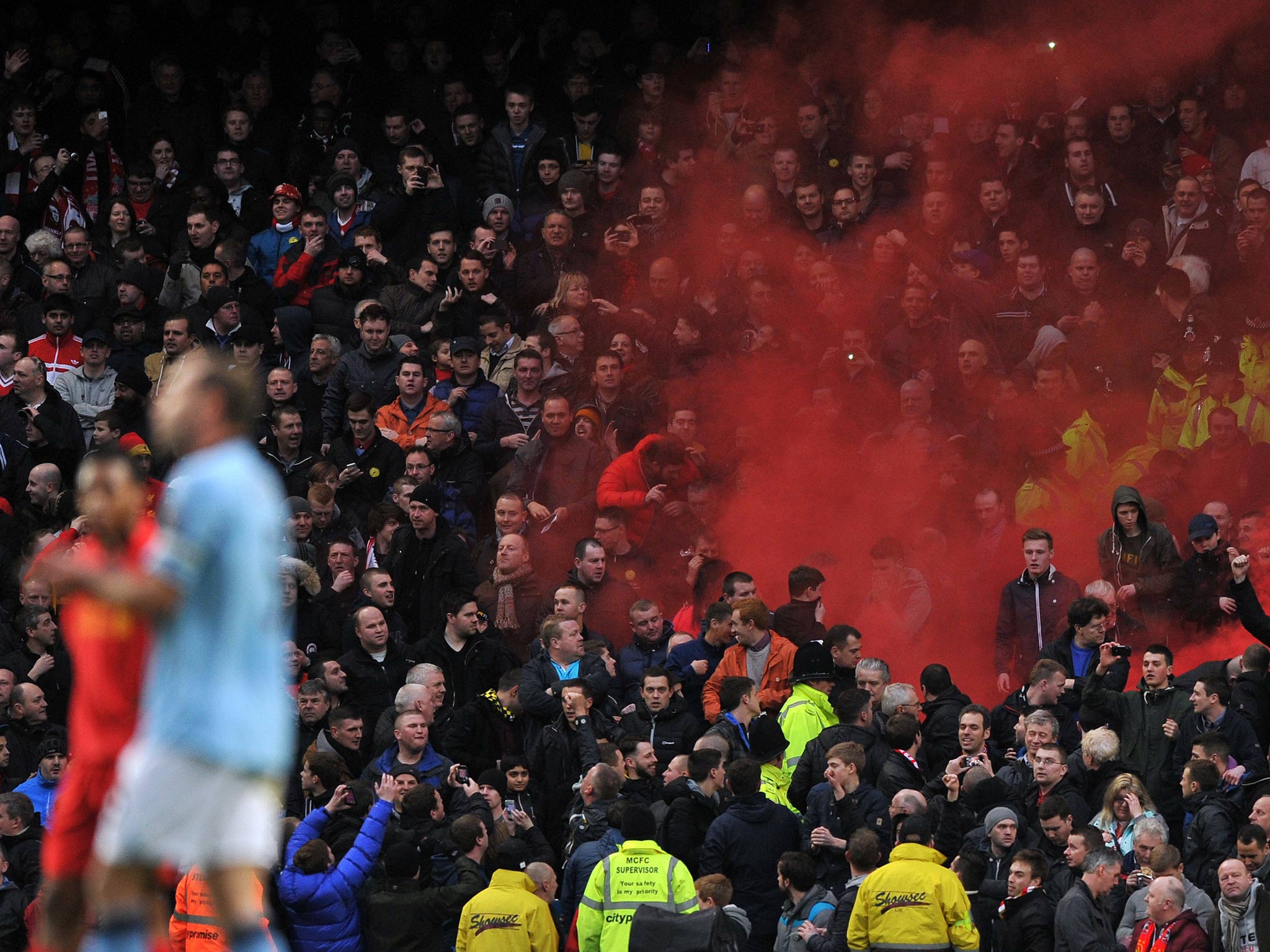 Liverpool fans set off a flare at the Etihad stadium