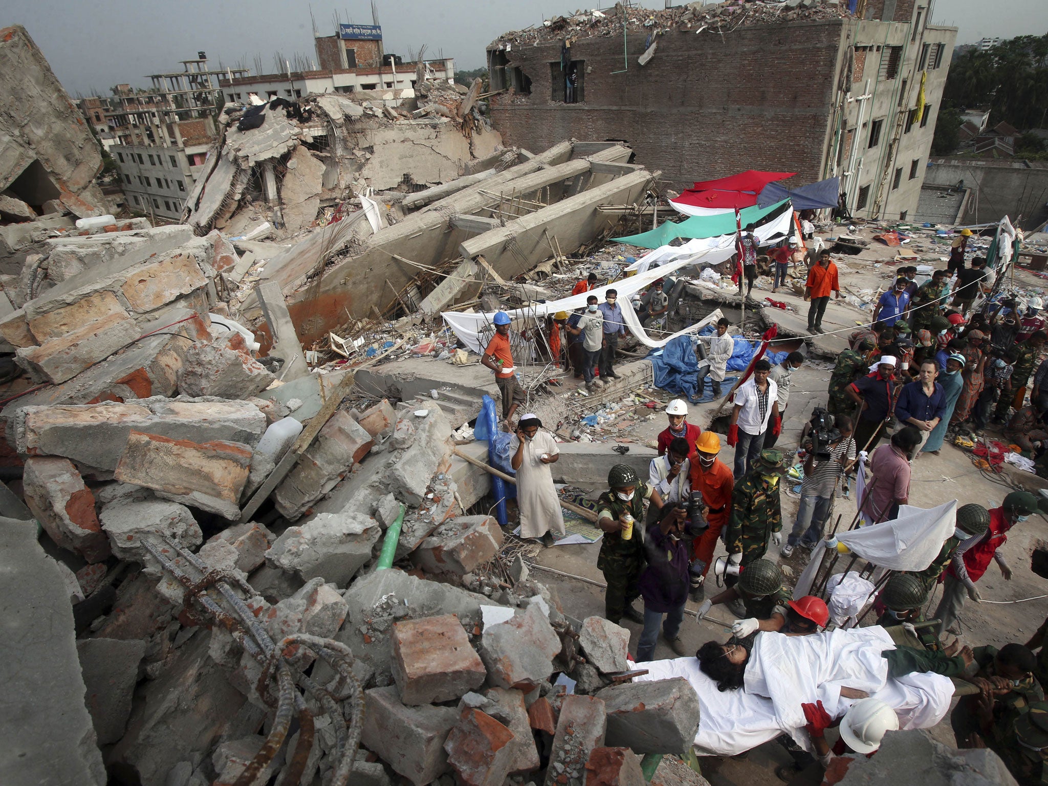 Dead and alive: The rubble of Bangladesh factory collapse gives up its ...