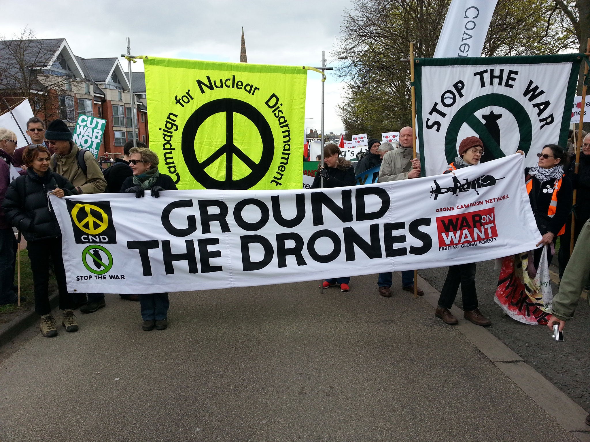 Remote-control warfare: Demonstrators on their way to RAF Waddington yesterday