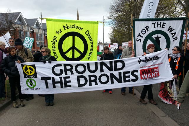 Remote-control warfare: Demonstrators on their way to RAF Waddington yesterday