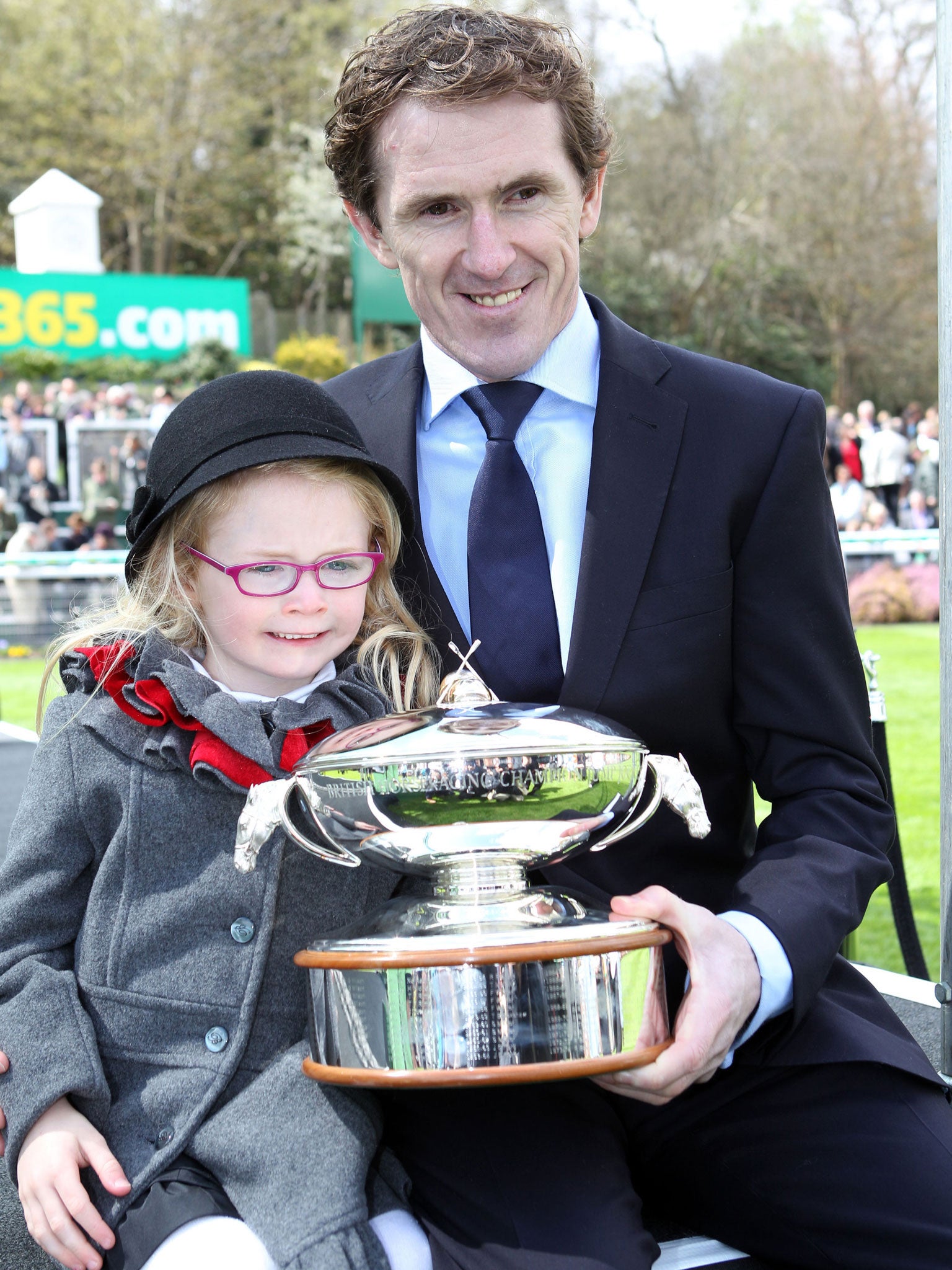 Winning Habit: Tony McCoy, with his daughter Eve, holds the jockey’s trophy at Sandown