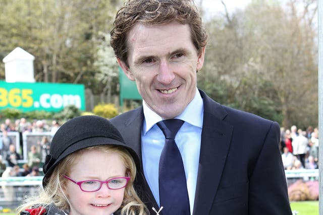 Winning Habit: Tony McCoy, with his daughter Eve, holds the jockey’s trophy at Sandown