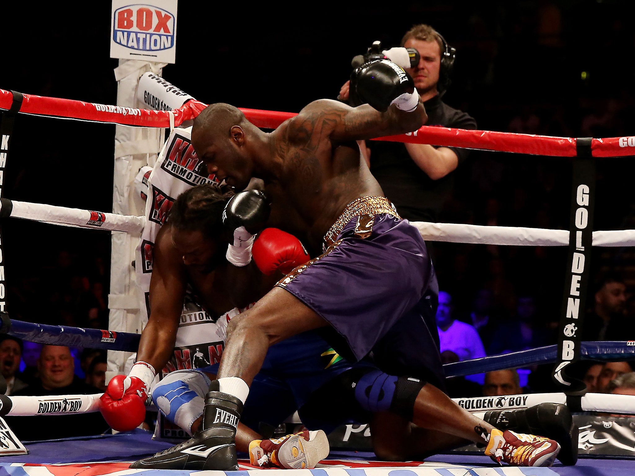 No quarter: Deontay Wilder keeps battering Audley Harrison after hitting the British fighter with a big right hand