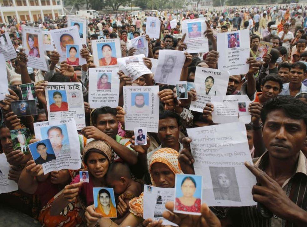 Worried relatives hold pictured of their loved ones, still missing after the Dhaka factory disaster
