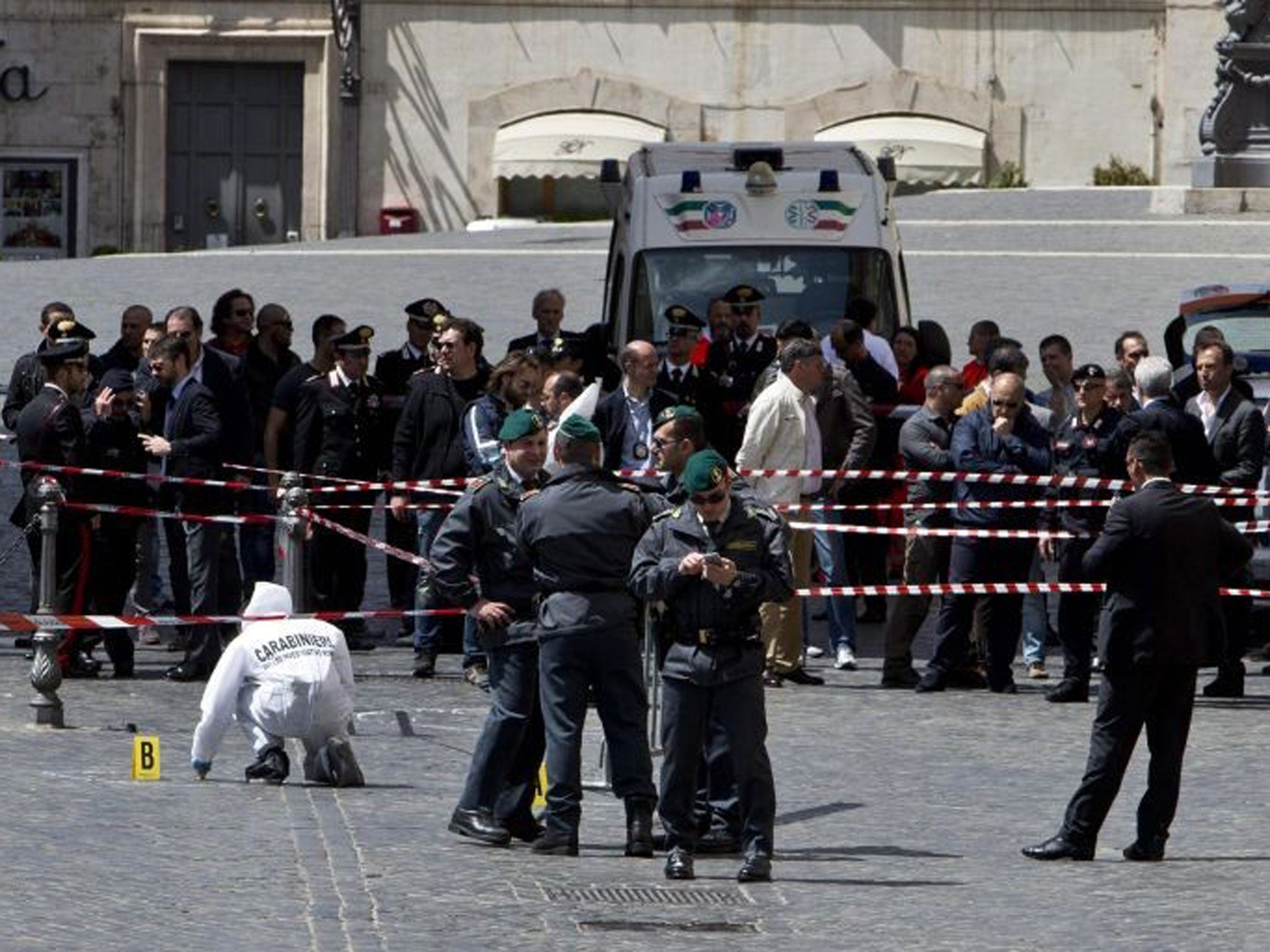 Forensic police investigate the site of a shooting outside Palazzo Chigi, the Italian Prime Minister's offices