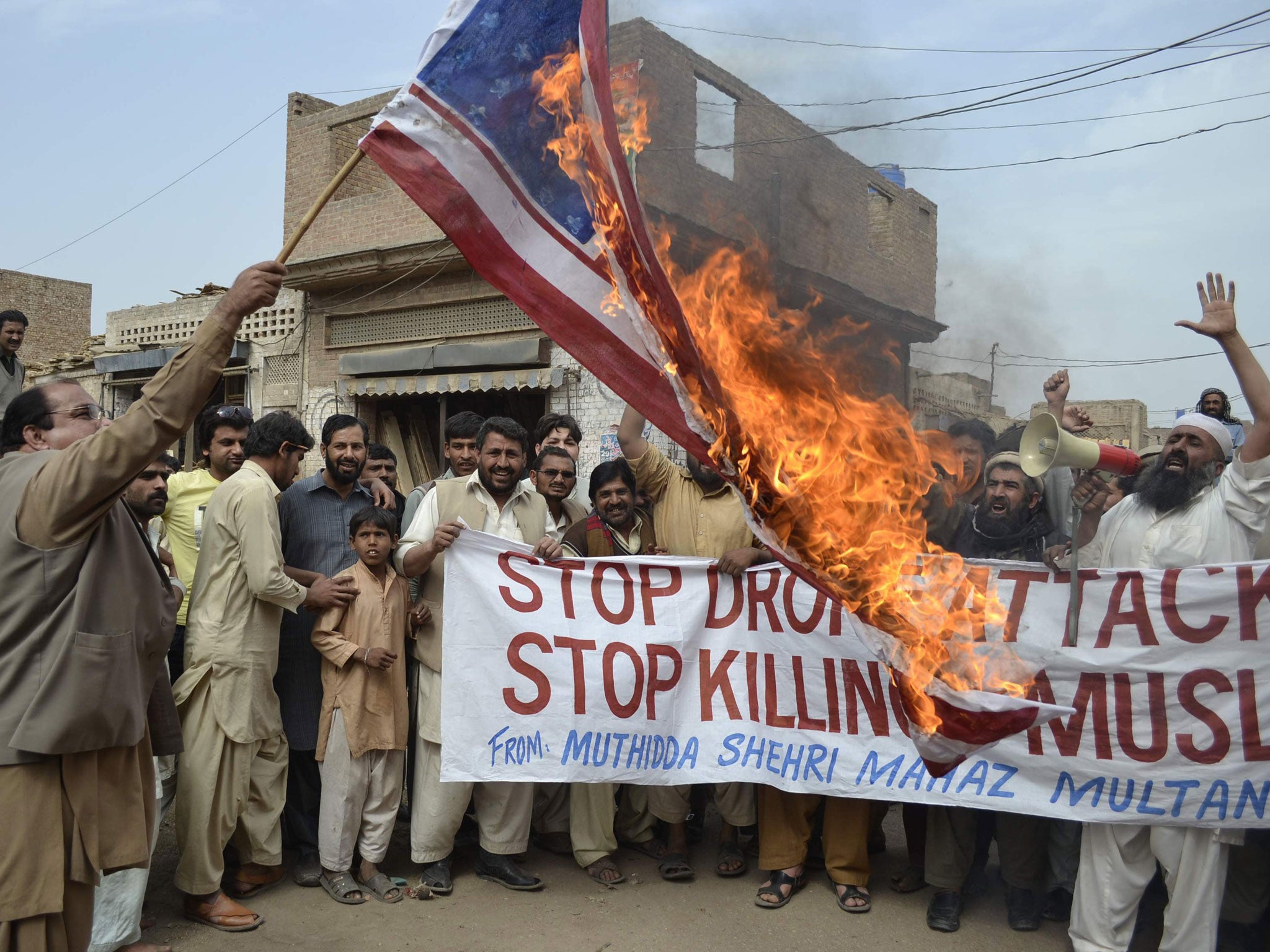 Activists of Pakistan Muthidda Shehri Mahaz burn the US flag during a protest in Multan on March 14, 2012, against US drone attacks. A US drone strike in Pakistan's lawless tribal belt on March 13 killed eight fighters supporting the Taliban in Afghanista