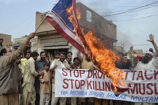 Activists of Pakistan Muthidda Shehri Mahaz burn the US flag during a protest in Multan on March 14, 2012, against US drone attacks. A US drone strike in Pakistan's lawless tribal belt on March 13 killed eight fighters supporting the Taliban in Afghanista