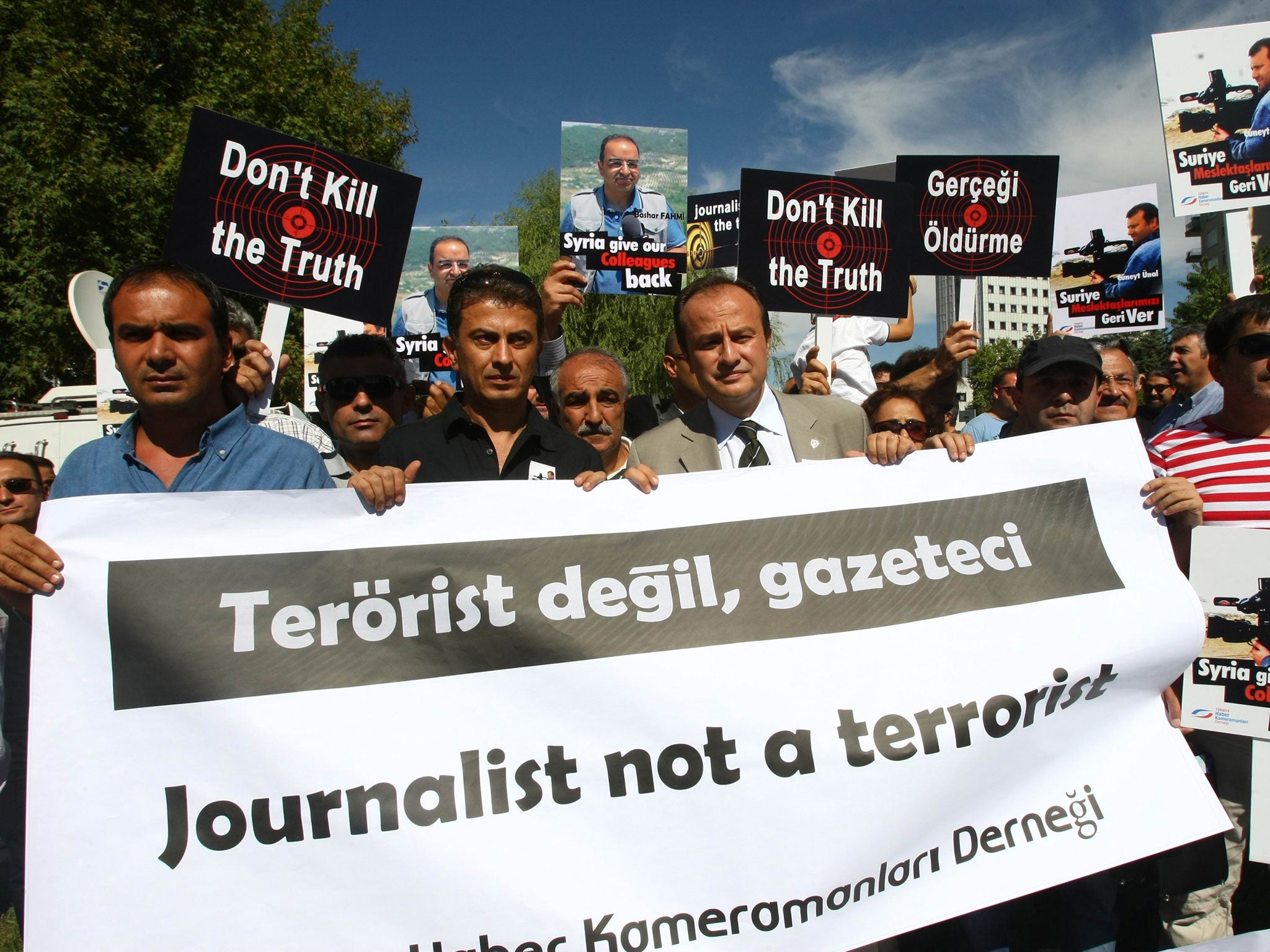 More than 100 Turkish journalists protest in front of the Syrian Embassy in Ankara on August 31, 2012, to demand the release of two Turkish reporters, cameraman Cuneyt Unal and TV correspondent Bashar Fahmi, reportedly being held by the regime of Syrian President Bashar al-Assad. Turkish cameraman Cuneyt Unal and his colleague Bashar Fahmi, who both work for the US-funded al-Hurra network, have been missing in Syria for 11 days and are reportedly being held by government troops.