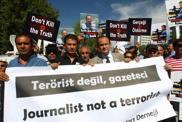 More than 100 Turkish journalists protest in front of the Syrian Embassy in Ankara on August 31, 2012, to demand the release of two Turkish reporters, cameraman Cuneyt Unal and TV correspondent Bashar Fahmi, reportedly being held by the regime of Syrian President Bashar al-Assad. Turkish cameraman Cuneyt Unal and his colleague Bashar Fahmi, who both work for the US-funded al-Hurra network, have been missing in Syria for 11 days and are reportedly being held by government troops.