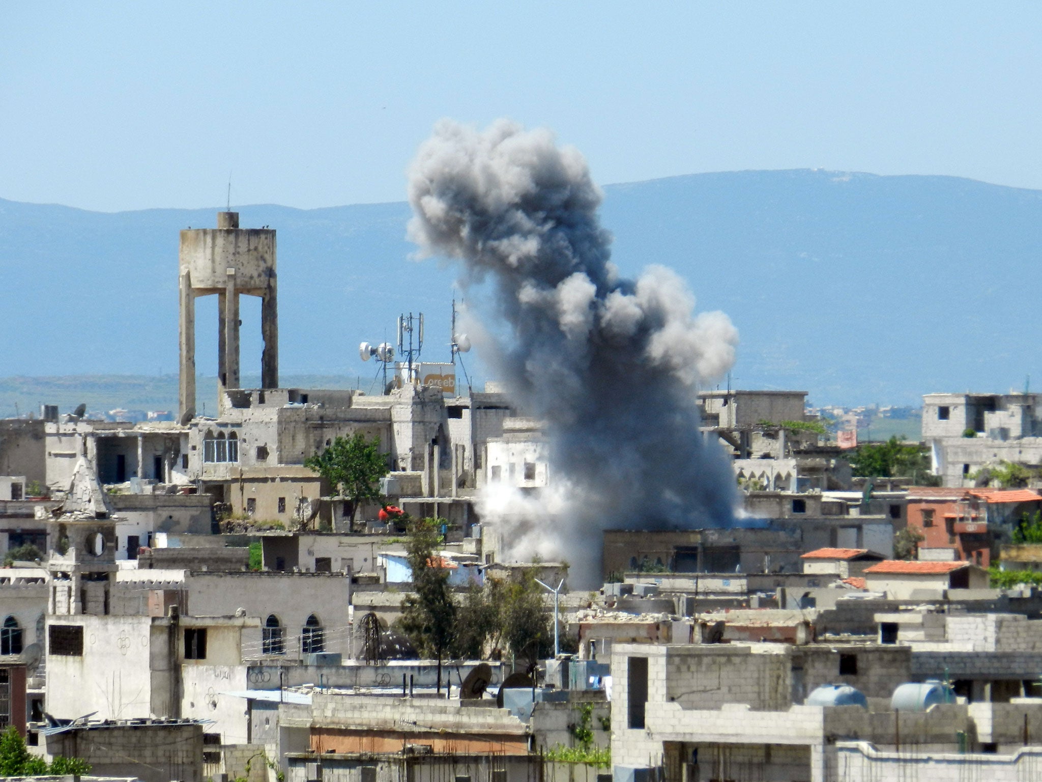 A picture taken on April 26, 2013 shows smoke rising after shelling in Houla in Syria's Homs province. The opposition National Coalition has accused the regime of using chemical weapons in the northern province of Aleppo, in Homs in central Syria, and in rebel-held areas near Damascus.