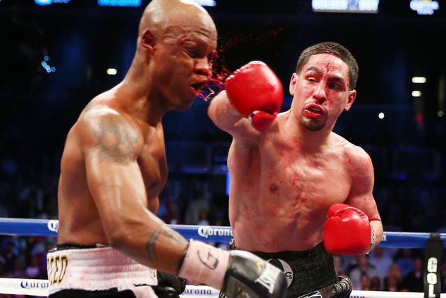 Danny Garcia, right, who could face Amir Khan in the future, lands a heavy blow on Zab Judah in their bloody light welterweight title clash
