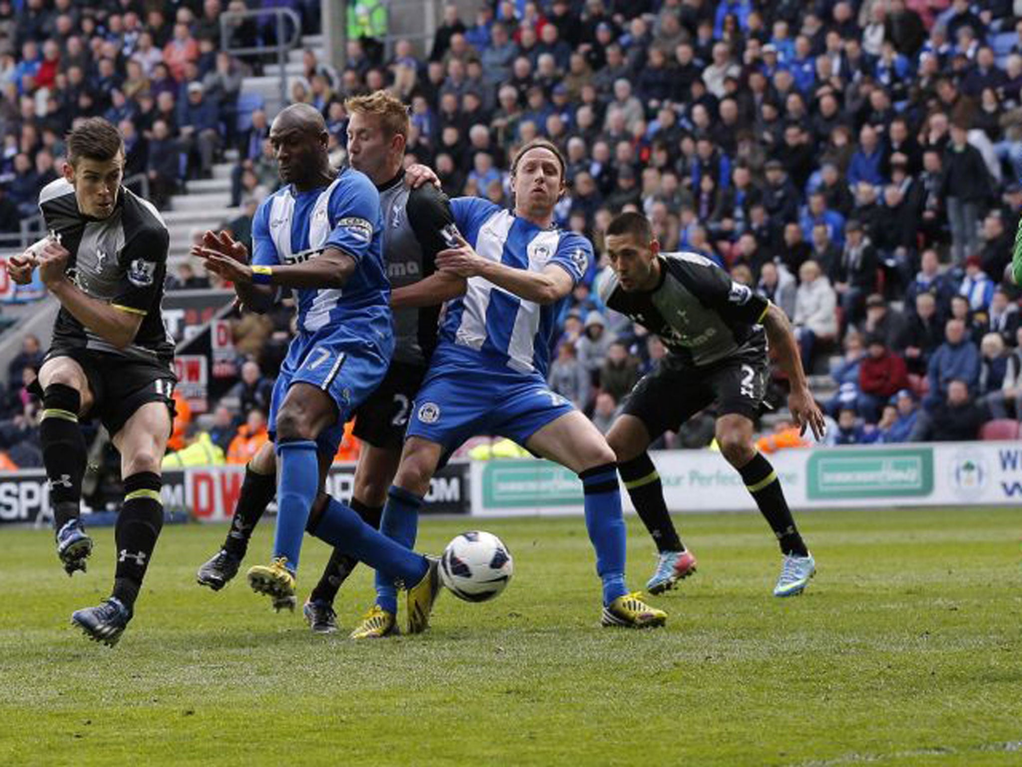 Emmerson Boyce (second left) deflects the ball into his own net