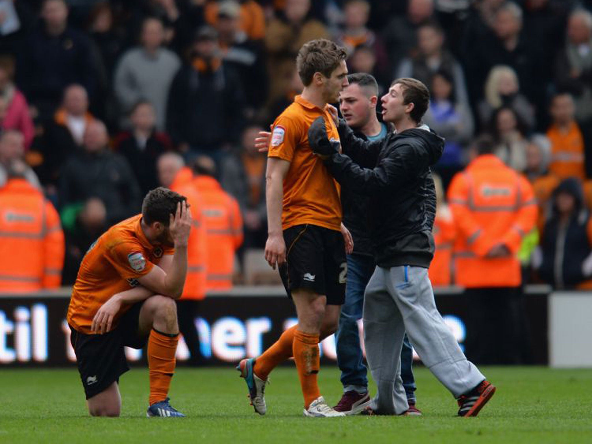 Kevin Doyle is surrounded by fans after the match on Saturday while his team-mate Roger Johnson holds his head in disbelief