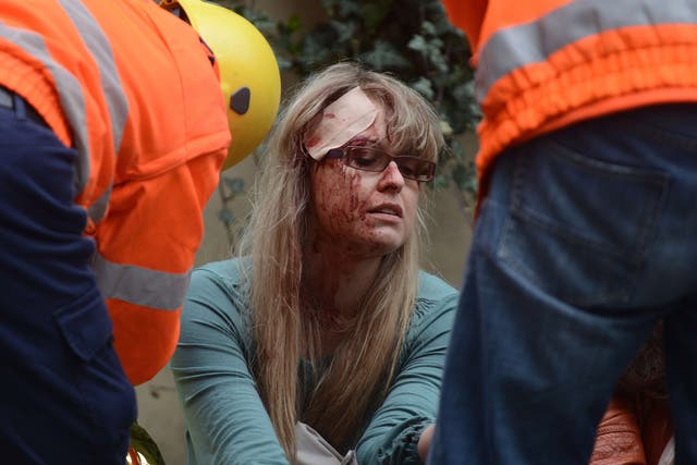 Rescue workers take care of woman injured by a powerful gas blast in Prague