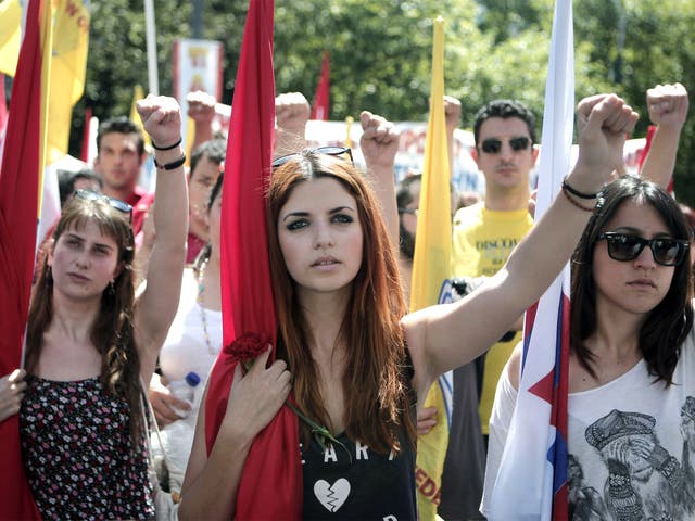 Members of pro-communist union PAME raise their fists during a protest in Athens