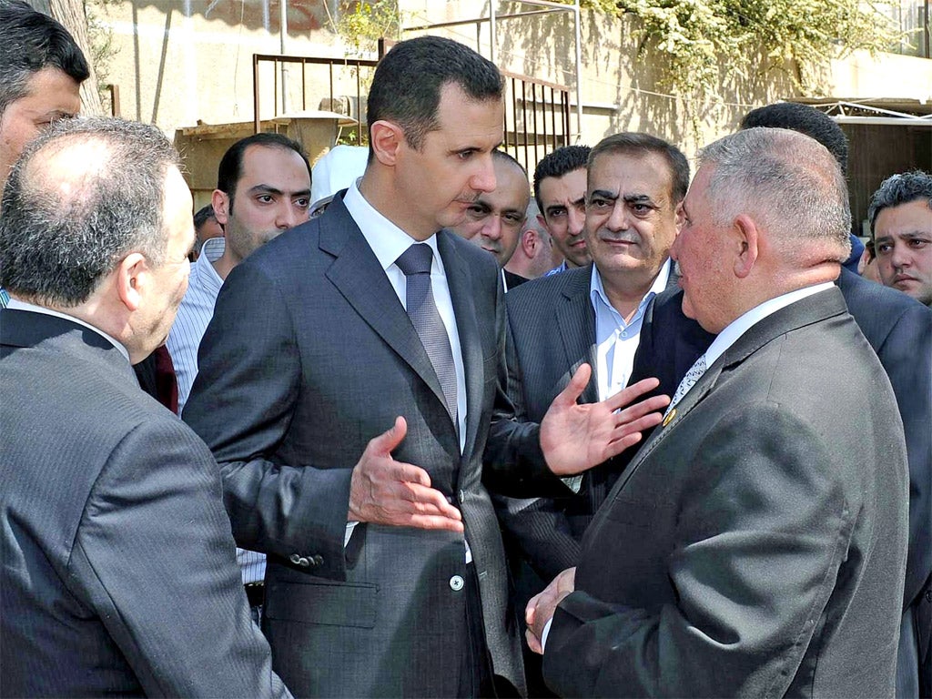 Bashar al-Assad makes a rare public appearance at a power station in Damascus yesterday