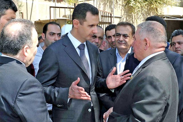 Bashar al-Assad makes a rare public appearance at a power station in Damascus yesterday