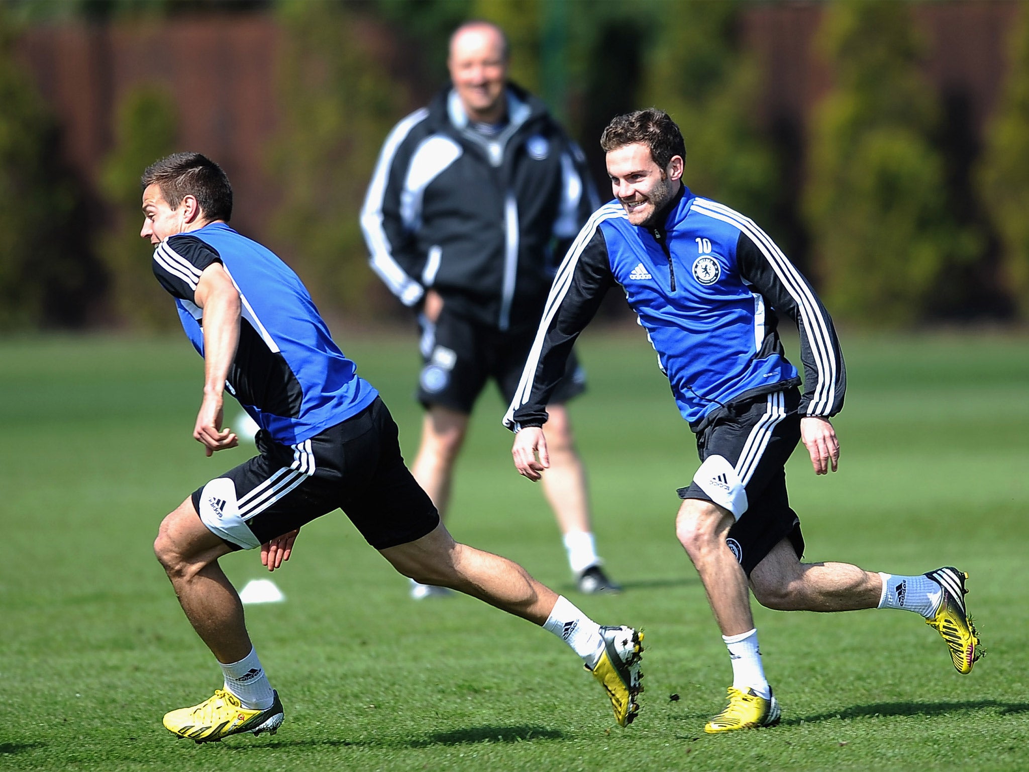 Juan Mata (right) and Cesar Azpilicueta enjoy training yesterday as Rafa Benitez looks on