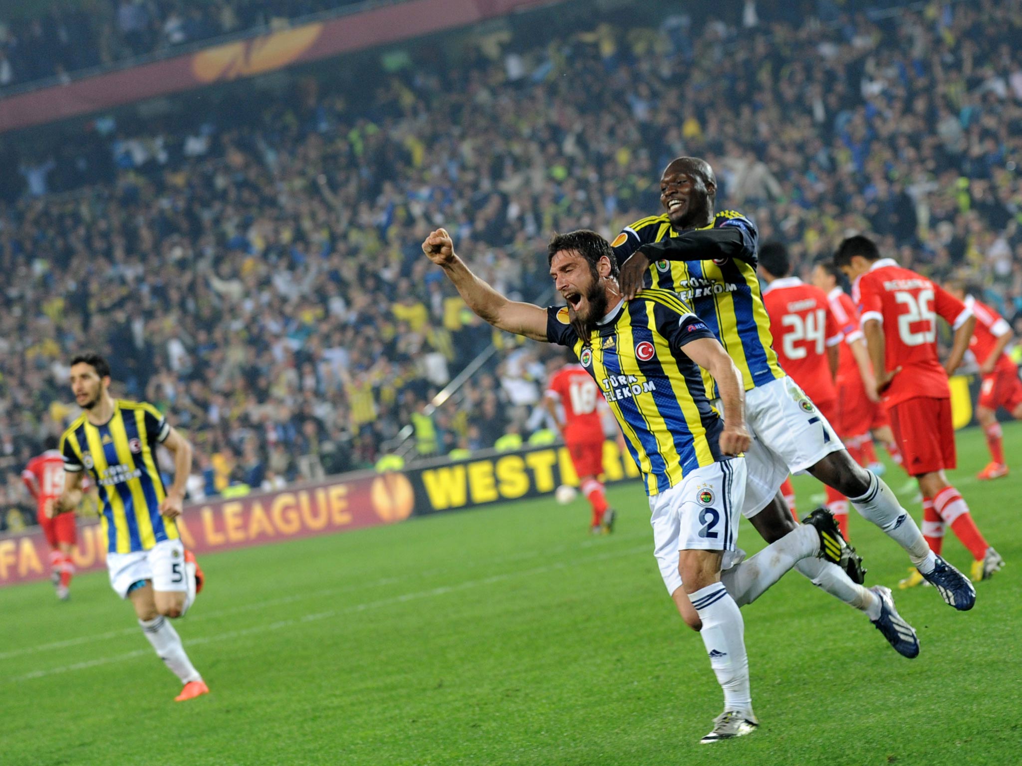Fenerbahce players celebrate during the first leg