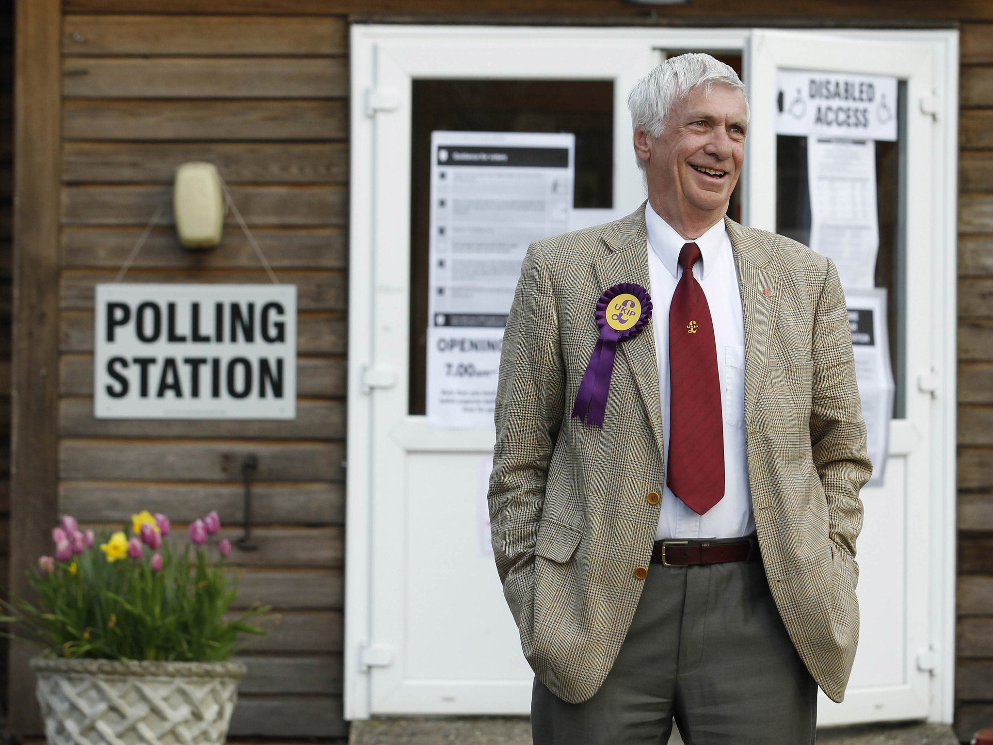 Norman Taylor, the UK Independence Party (UKIP) candidate in the Ashford Central local elections, smiles after casting his vote at Bethersden Village Hall, in Bethersden, near Ashford