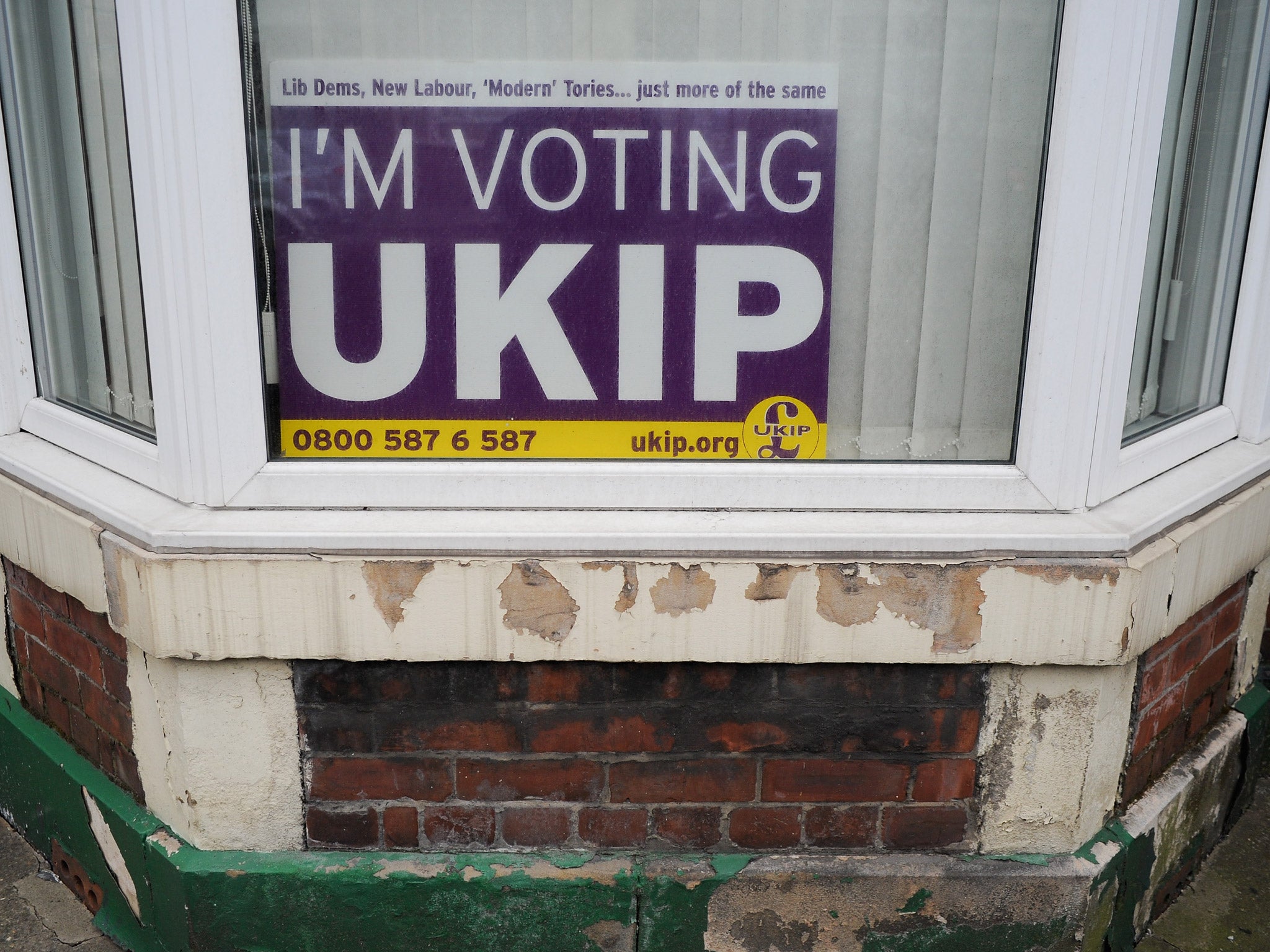 A UKIP posted is displayed in a house window