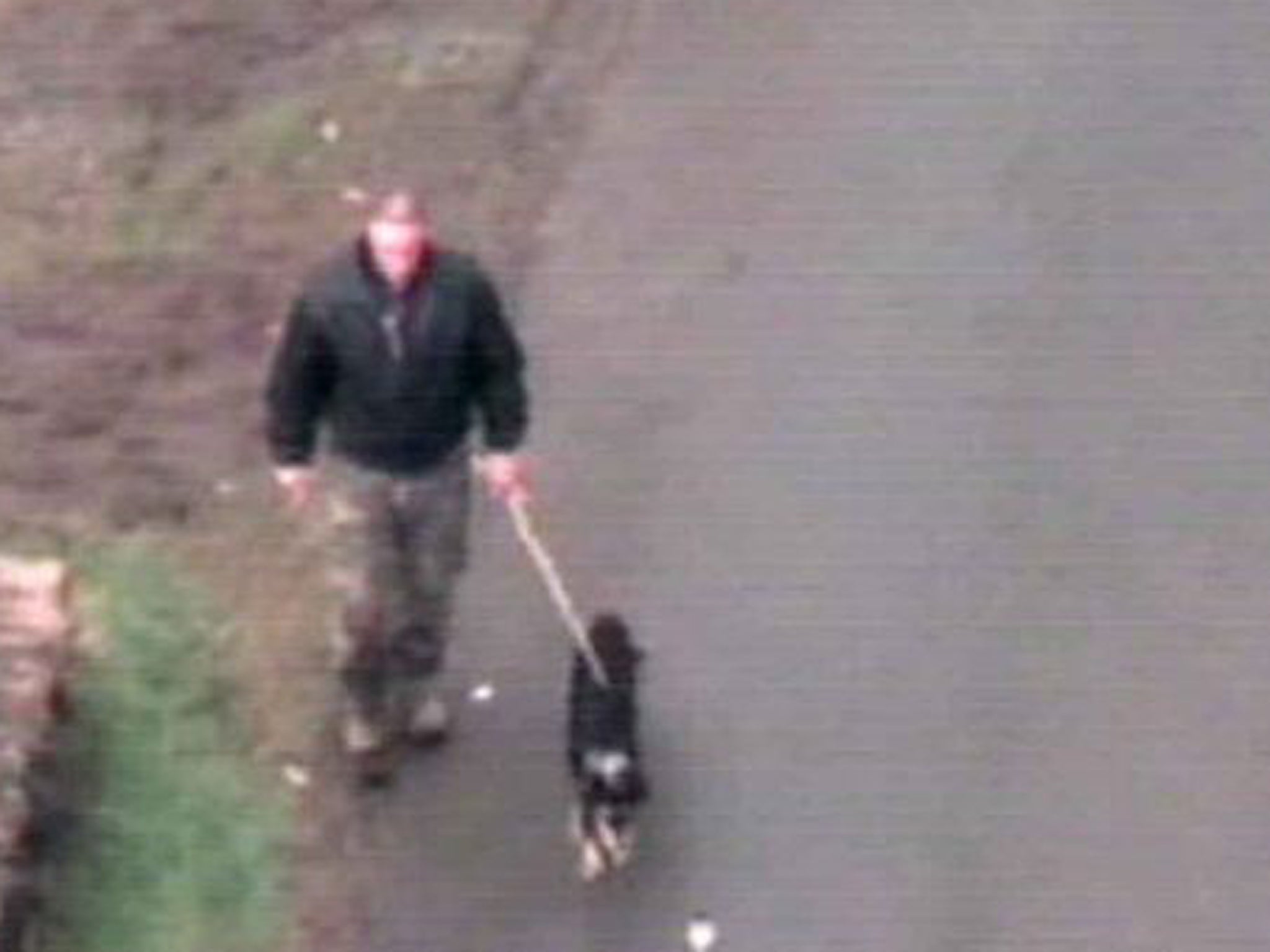 CCTV footage taken from a police helicopter shows Mark Bridger walking his dog the day after April Jones went missing