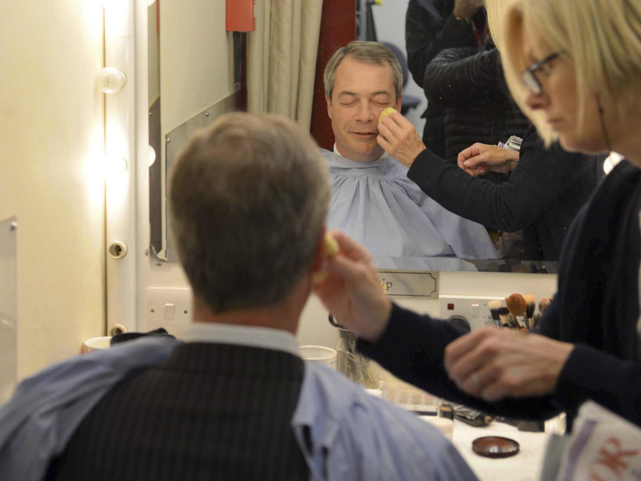 UK Independence Party (UKIP) leader Nigel Farage sits wearing make-up before appearing in the "BBC Vote 2013" studio at Milbank in London