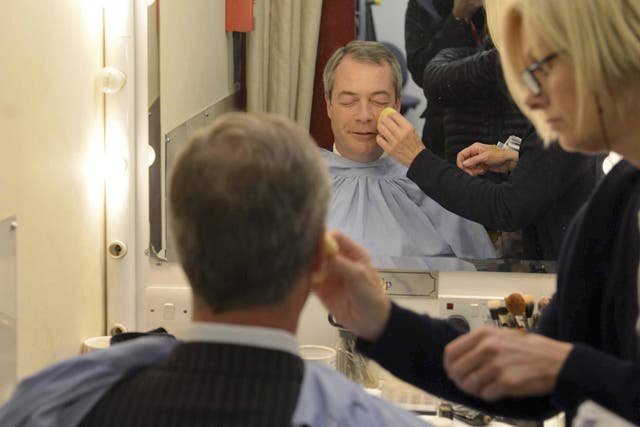 UK Independence Party (UKIP) leader Nigel Farage sits wearing make-up before appearing in the "BBC Vote 2013" studio at Milbank in London
