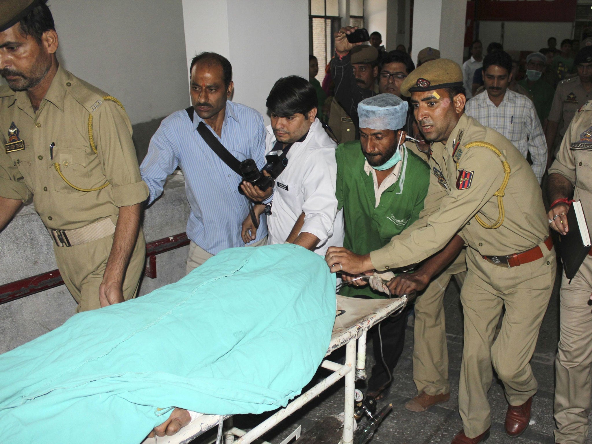 Police and hospital staff shift Sanaullah Haq, a Pakistani prisoner, to an intensive care ward in a hospital in Jammu