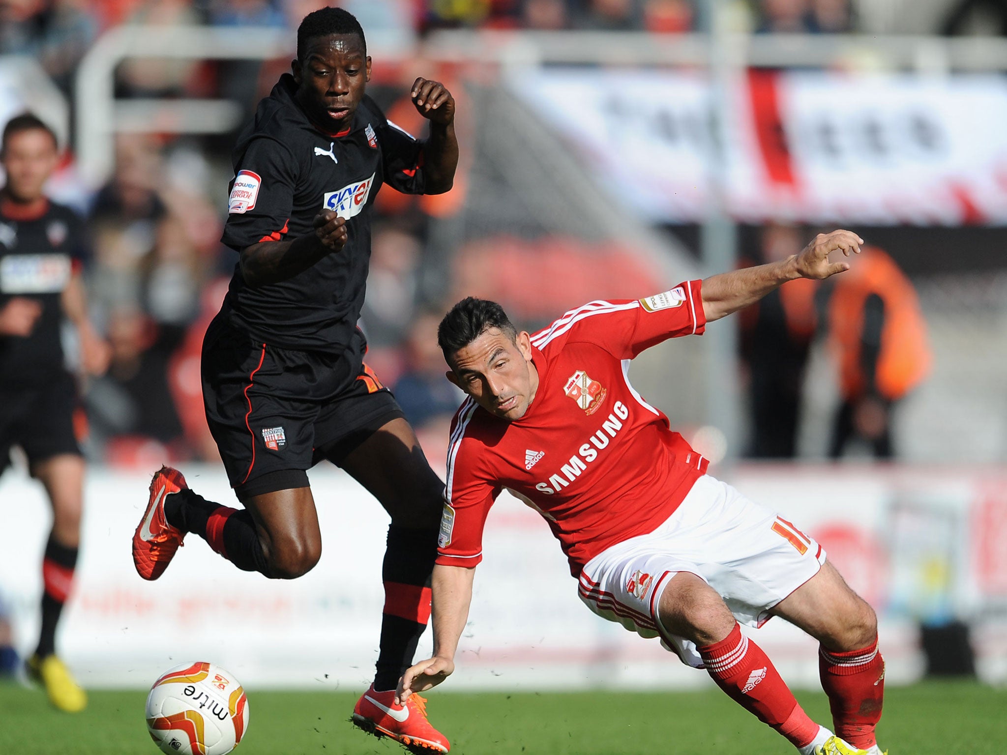 Fall guy: Swindon’s Gary Roberts tumbles under pressure from Wright-Phillips