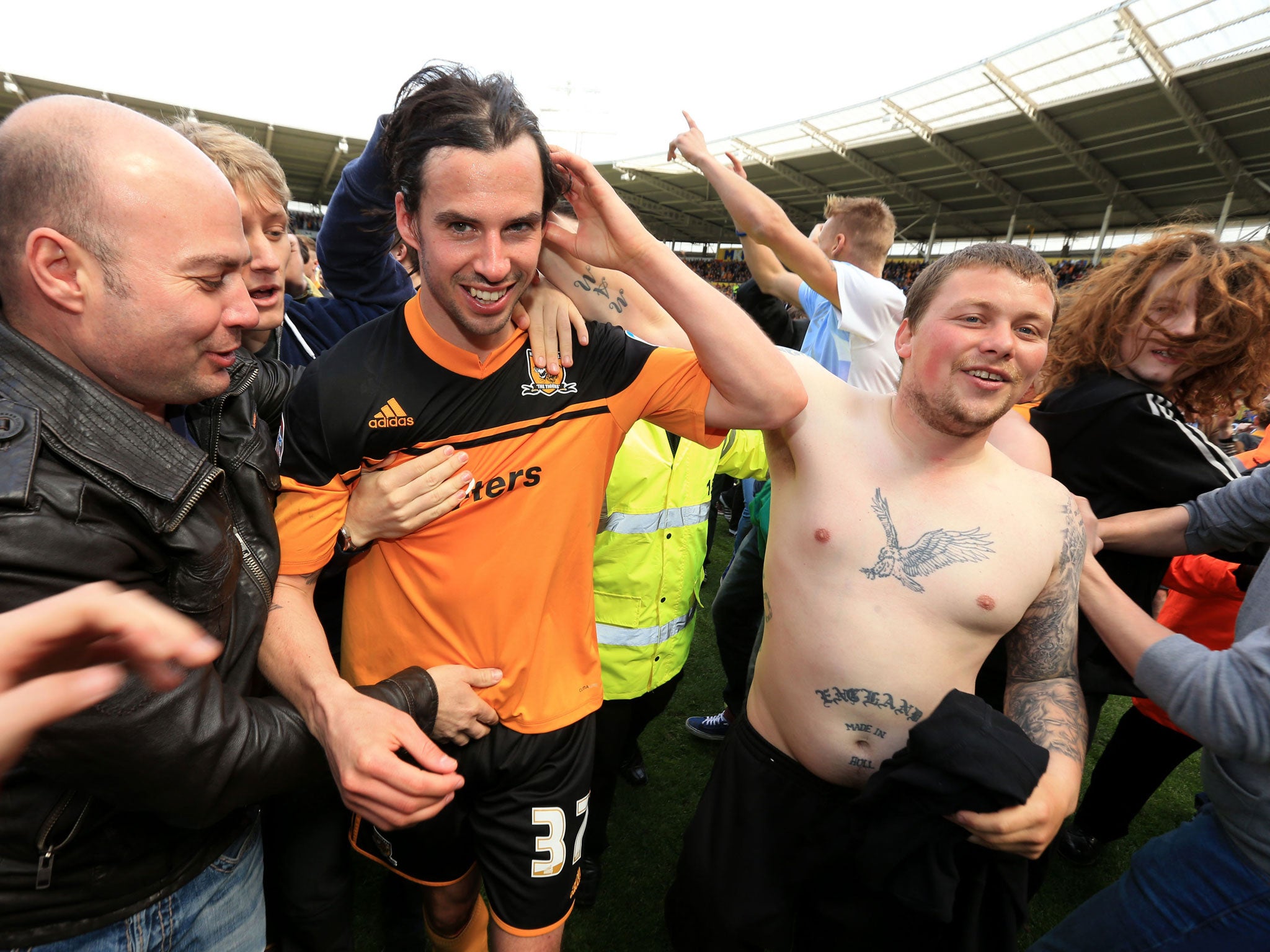 Hull City's George Boyd is mobbed by fans as he leaves the pitch