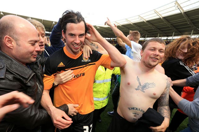Hull City's George Boyd is mobbed by fans as he leaves the pitch