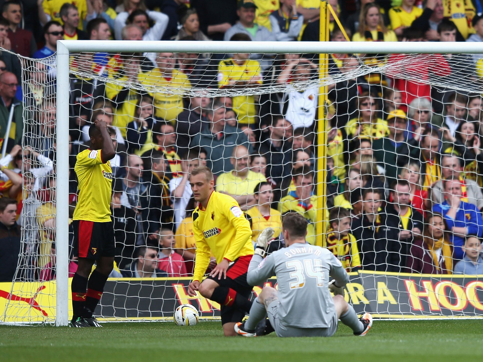 Substitute goalkeeper Jack Bonham of Watford sits on the ground dejected after the opening goal scored by Dominic Poleon