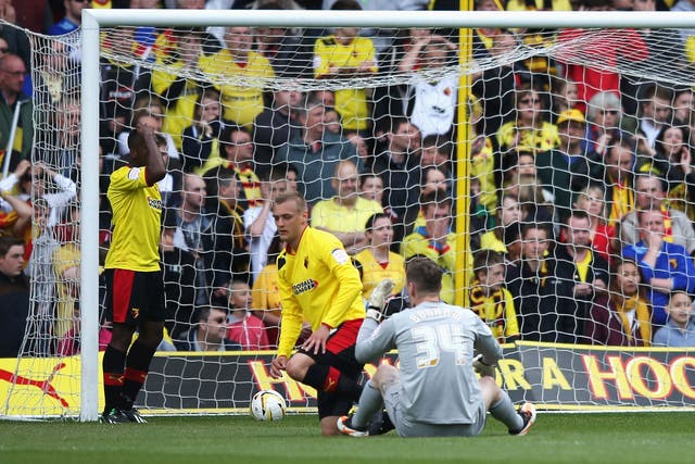Substitute goalkeeper Jack Bonham of Watford sits on the ground dejected after the opening goal scored by Dominic Poleon
